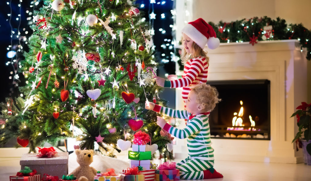 children by Christmas tree